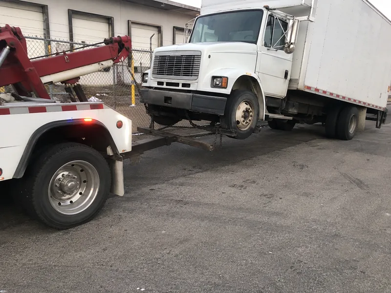 Heavy duty wrecker towing a box truck in Atlanta